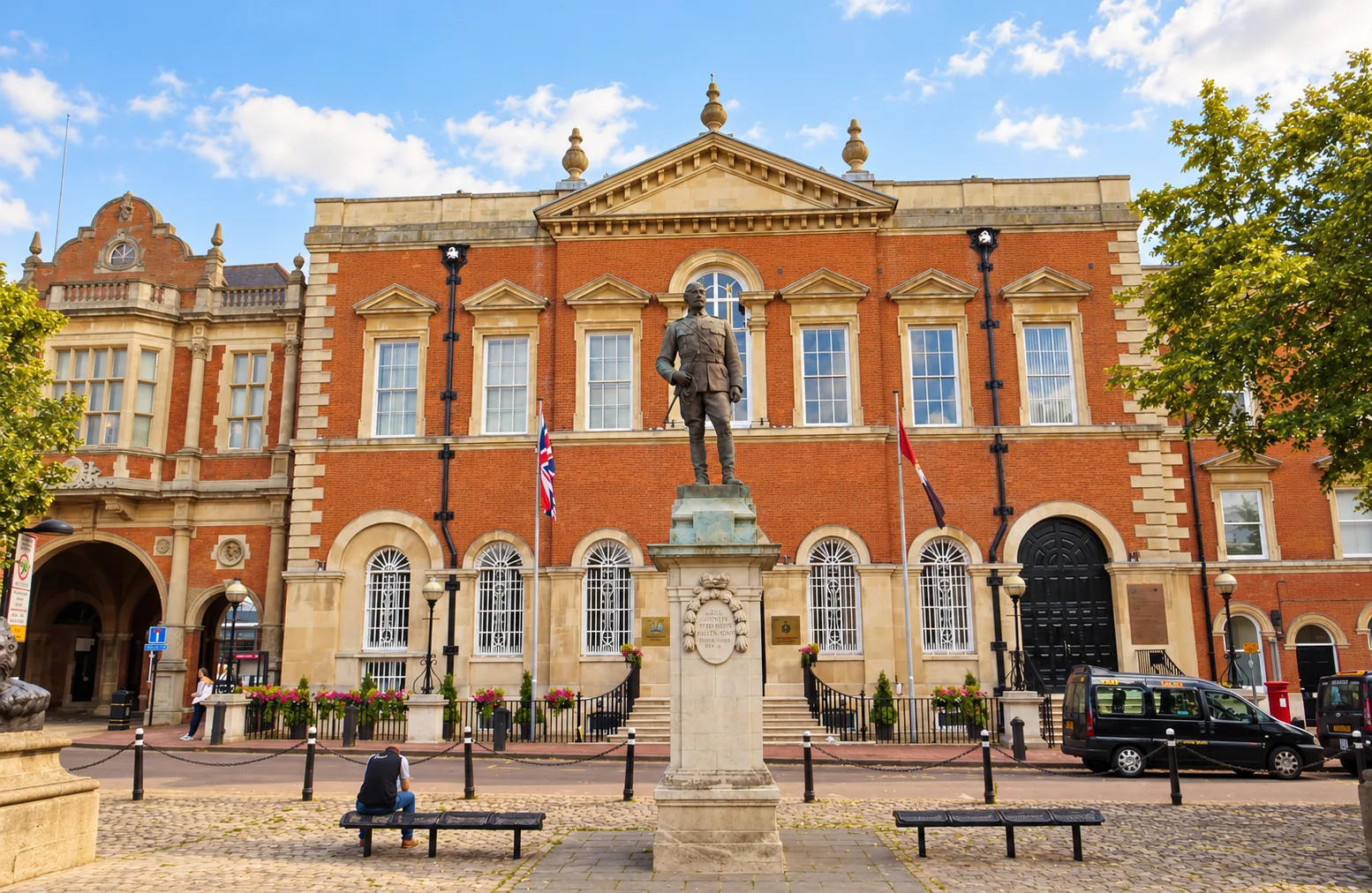 Warm colour-edited photograph of Aylesbury Crown Court and the statue in Market Square